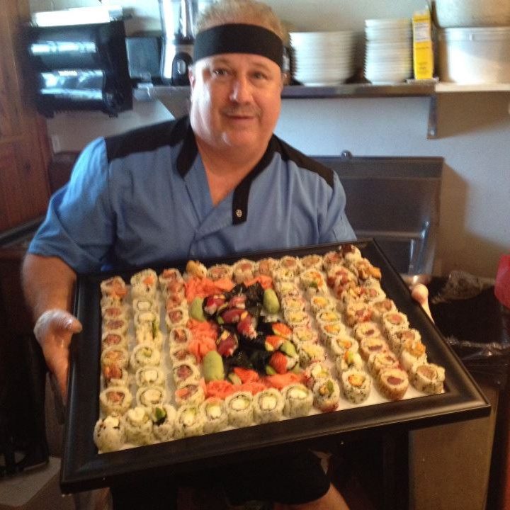 Chef Don in a group photo with a familiar guest at Oyster Creek